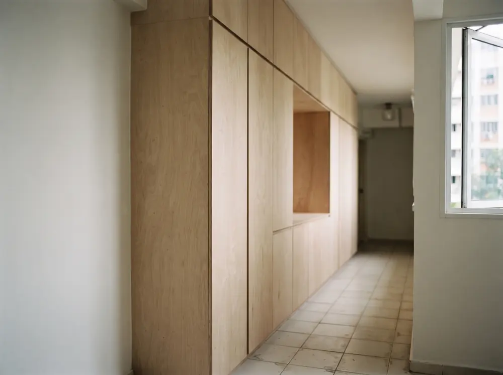 Full-height carpentry carcasses along a corridor wall in a 4-room BTO renovation