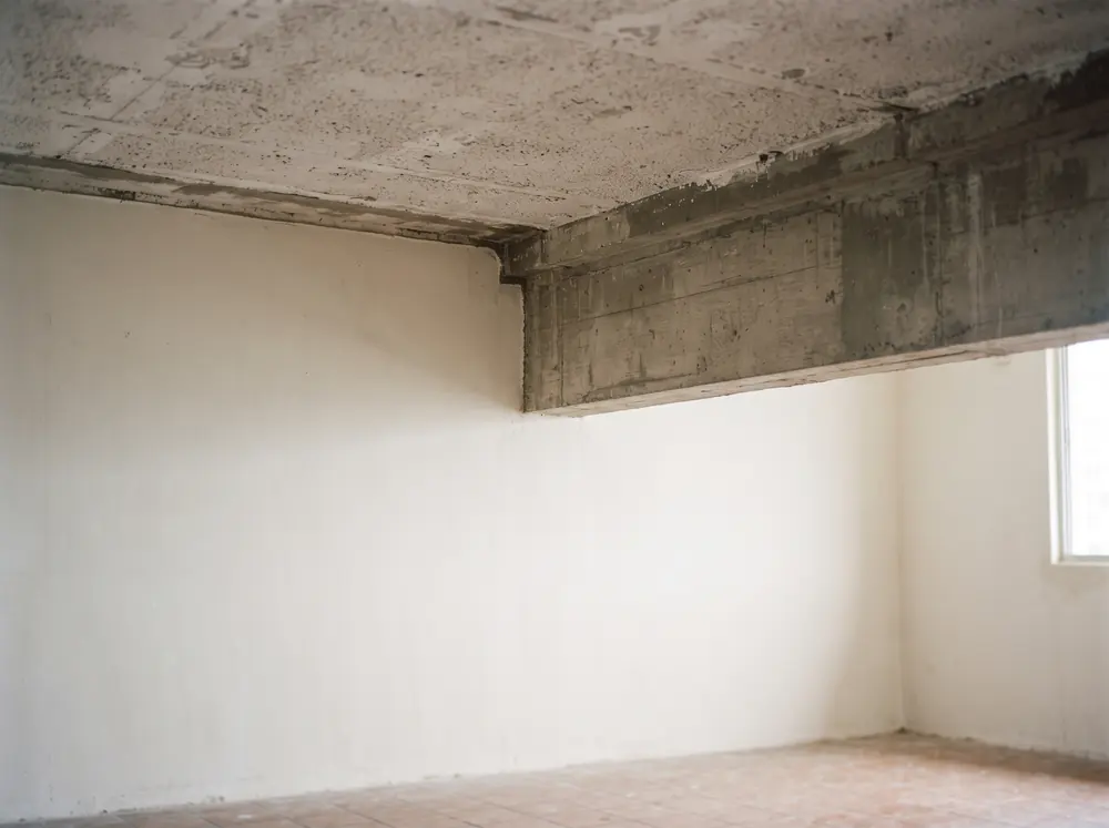 A ceiling slab meeting a structural beam, the element HDB renovation guidelines protect