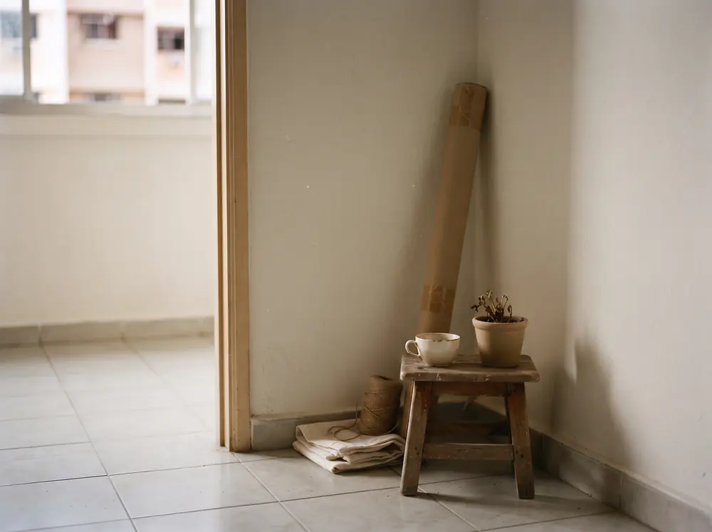 A bare room corner lit softly from a concealed cove