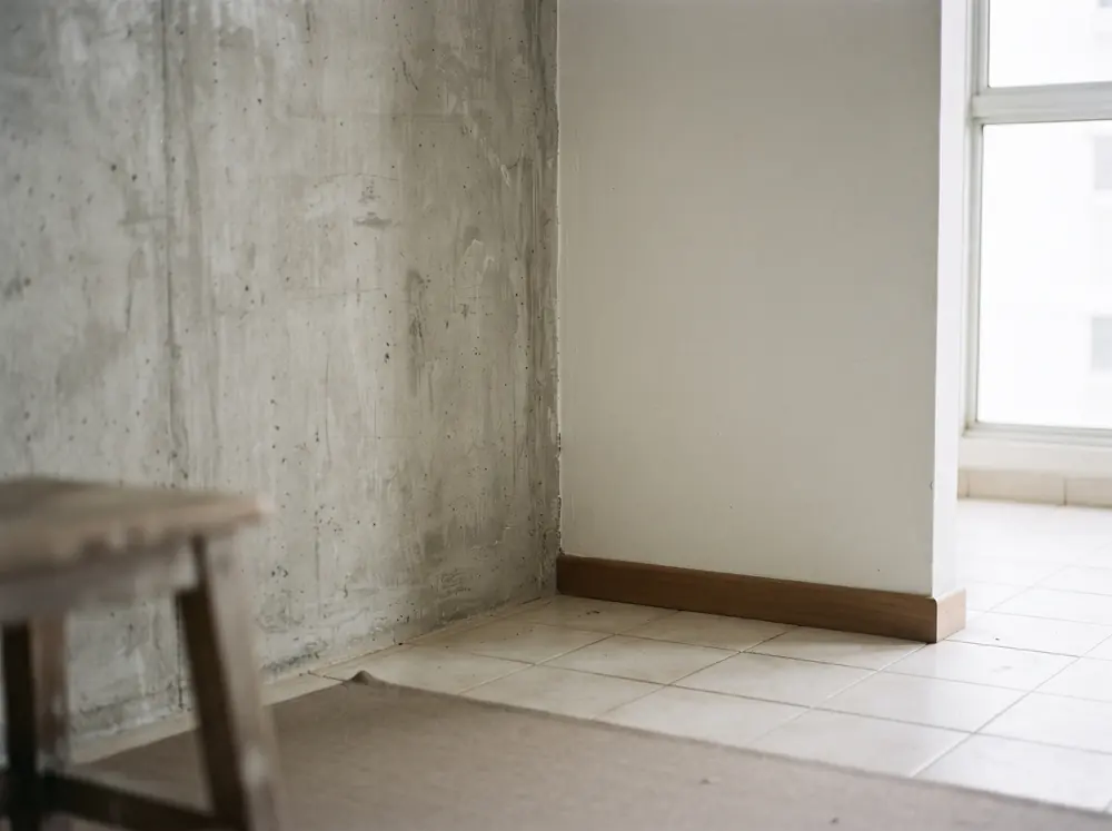 A concrete structural wall beside a lighter partition wall