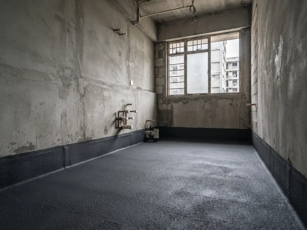 A bathroom shell with waterproofing membrane on the floor