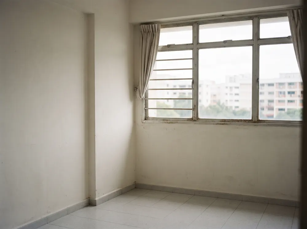 An empty apartment room with bare walls